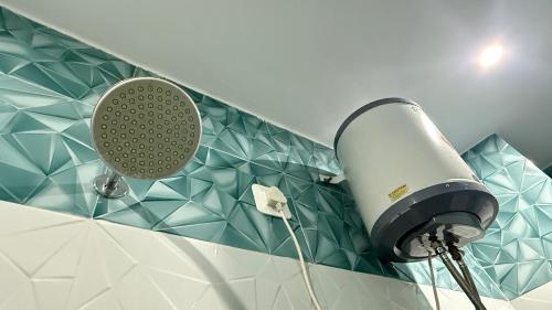 a blow dryer on the wall of a bathroom at D S valley in Rishīkesh