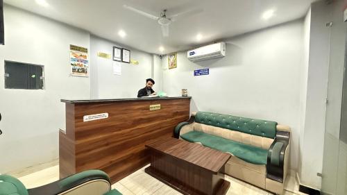 a man standing at a counter in a waiting room at D S valley in Rishīkesh