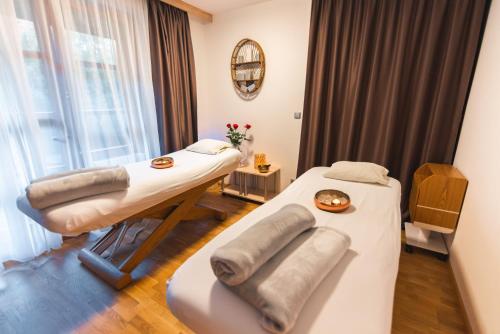 a room with two beds and a window at Maximus Resort in Brno