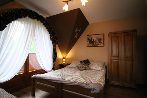 a bedroom with a bed and a window at U Repy in Bańska