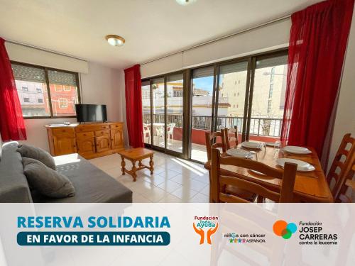 a living room with a couch and a table at Apartamentos Playa Oropesa 3000 in Oropesa del Mar