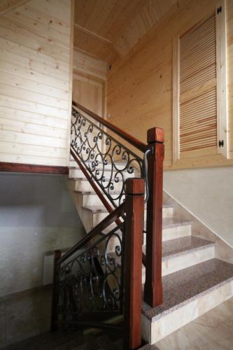 a staircase in a house with a wooden wall at U Repy in Bańska