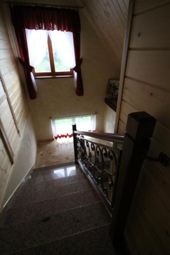 an attic stairway with a window and a stair case at U Repy in Bańska