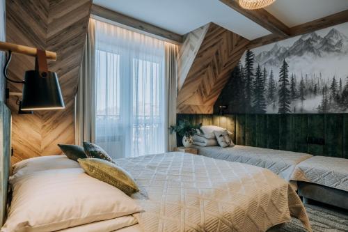 a bedroom with two beds and a large window at Pokoje Gościnne u Moniki Zakopane - 4 km do centrum in Zakopane