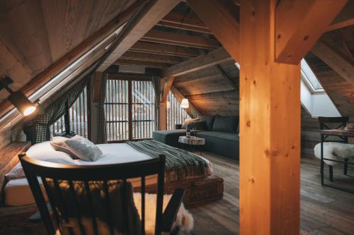 a room with a bed and a couch in a cabin at Domačija Majer'ca in Bohinj
