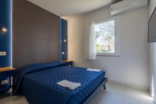 a bedroom with a blue bed and a window at Centro Vacanze Poker in Casalbordino