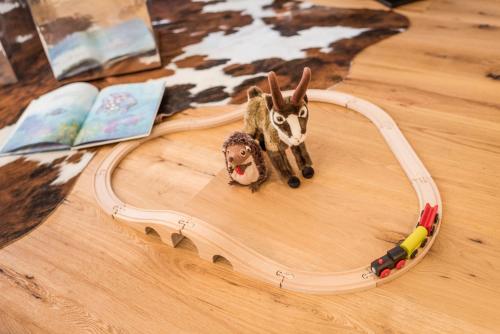 a toy rabbit and a toy train on a table at Andermatt Alpine Apartments in Andermatt