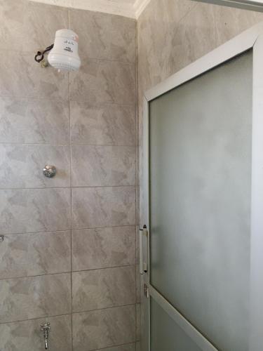 a shower with a glass door in a bathroom at Miranda suites in Bungoma
