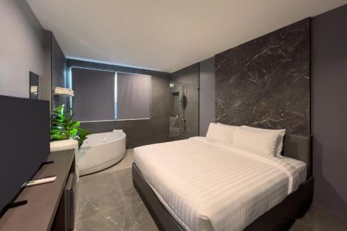 En eller flere senge i et værelse på HK Villa Resort