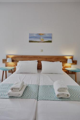 a bedroom with two beds with towels on them at Irene Studios in ayios Petros