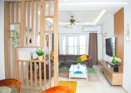 a living room with a couch and a table at Serenity Haven Luxe 2BR, Pool, Wi-Fi, AC, Netflix , DSTV, Gated, Sakumono in Agblesia