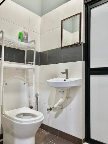 a bathroom with a toilet and a sink at Cabang View - Hillstay Retreat in Kampung Padang Masirat