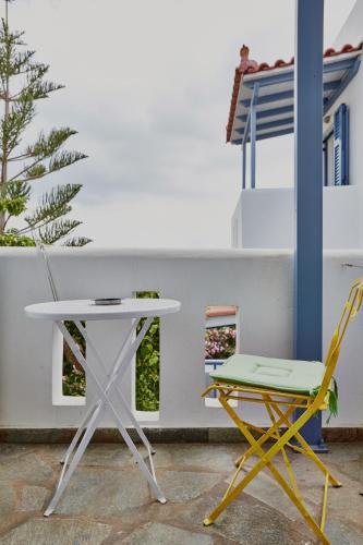 a white table and two chairs sitting next to a building at Irene Studios in ayios Petros