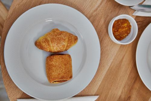 a white plate with two pieces of food on a table at Irene Studios in ayios Petros