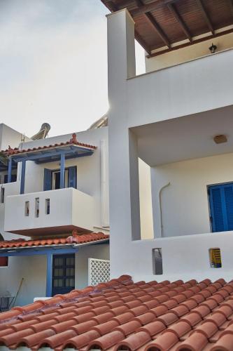 a view of a white building with a red roof at Irene Studios in ayios Petros