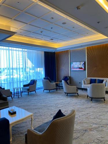 a lobby with couches and tables and chairs at AL HAYAT HOTEL in Sharjah