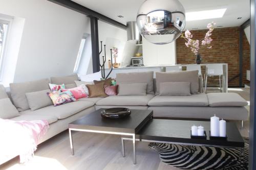a living room with a couch and a table at Magical Urban Retreat in London