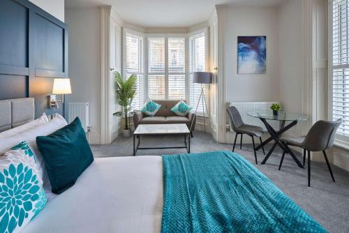 a bedroom with a bed and a table and chairs at Host & Stay - The Langley Hotel in Whitby
