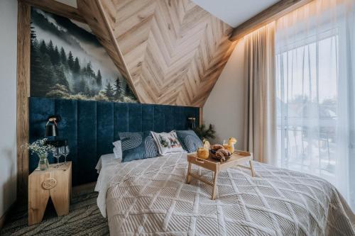 a bedroom with a large bed and a large window at Pokoje Gościnne u Moniki Zakopane - 4 km do centrum in Zakopane