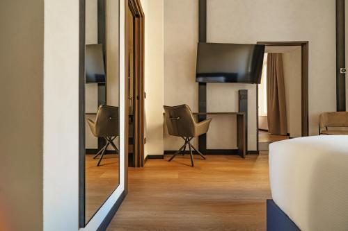 En eller flere senge i et værelse på Cavour Suites