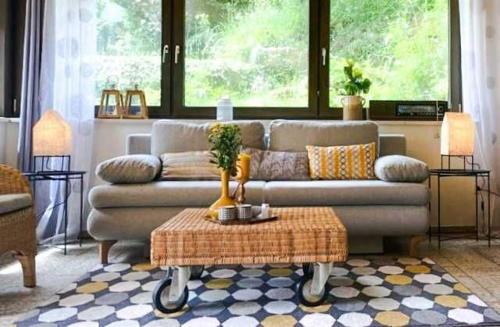 a living room with a couch and a table at Ferienwohnung Diesbrunnen in Ebermannstadt