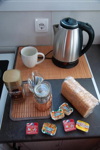 a table with a tea pot and some food on it at ΛΙΜΑΝΙ in Chios