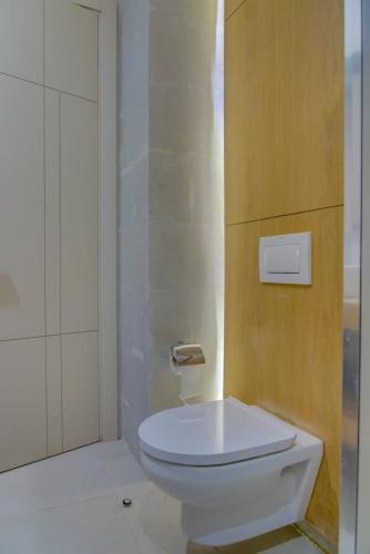 a bathroom with a white toilet and a shower at Charming Seaside Apartment with Pool & Direct Beach Access in Agadir nʼ Aït Sa