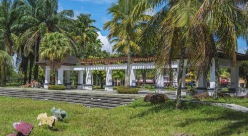 a building with palm trees in front of it at S Avenue Hotel in Johor Bahru