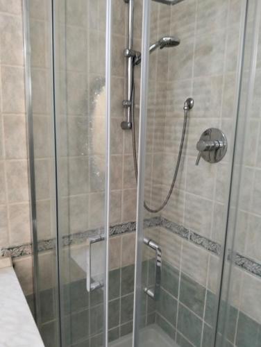 a shower with a glass door in a bathroom at Casa Ciuccetti in Baldichieri