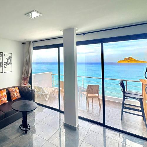 a living room with a view of the ocean at Dream View Nova in Rafrāf