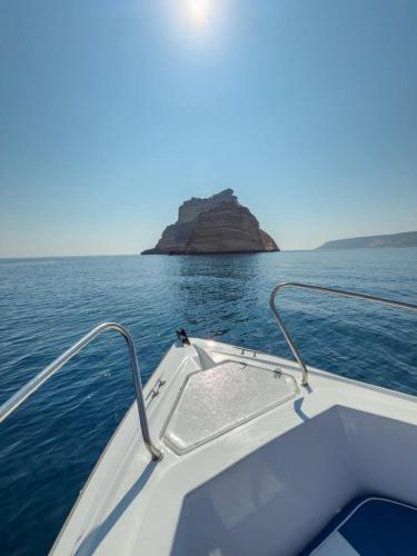 a boat on the water with an island in the background at Dream View Nova in Rafrāf