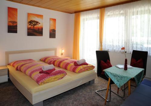 a bedroom with a bed with two pillows on it at Haus Stuttgart in Obernberg am Inn