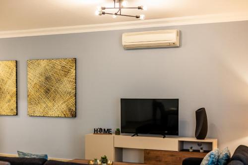 a living room with a flat screen tv on a wall at Luxury Apartments with Pool and Terrace, Top Location in Sliema
