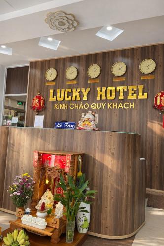 a lobby of a hotel with clocks on the wall at Lucky 1 Hotel in Trà Vinh