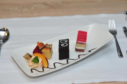 a plate with different types of desserts on a table at Thermal Hotel Balance Lenti in Lenti