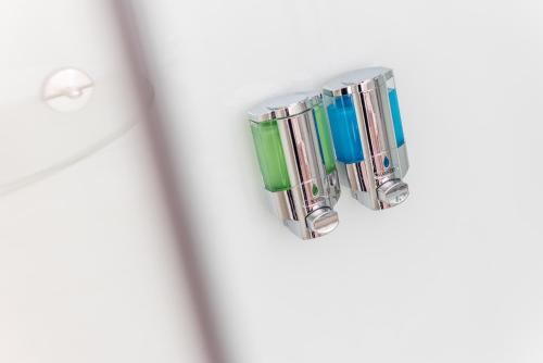 a group of green and blue glass clips on a door at Schäfers Hotel, Self-Check-in, Cafe und Bäcker am Hotel in Vechta
