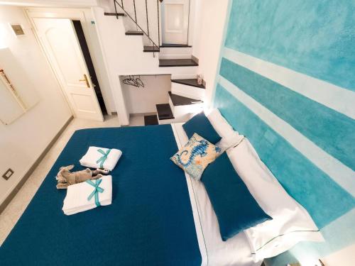a bedroom with a bed with blue sheets and pillows at Picagetta Tiny Room with AC in Vernazza