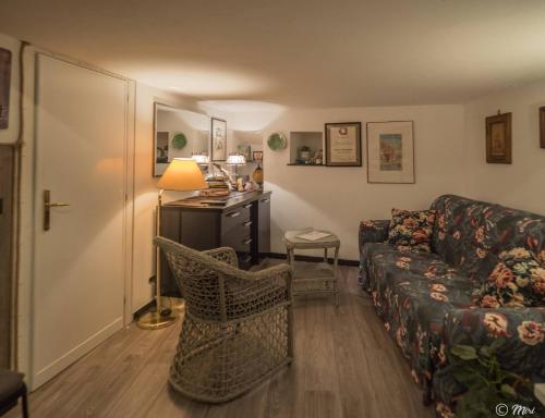 a living room with a couch and a desk at Petrella's Point Studio with AC in Vernazza