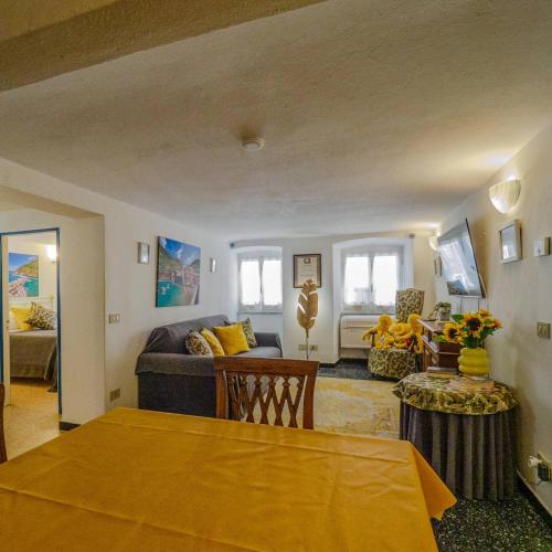 a living room with a couch and a table at Mainetta Sea View Apartment with AC in Vernazza