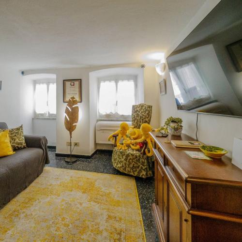 a living room with a couch and a table with a teddy bear at Mainetta Sea View Apartment with AC in Vernazza