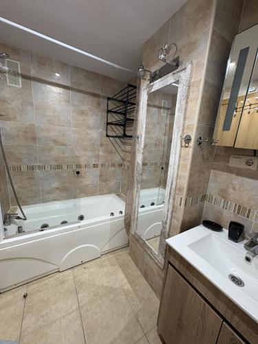 a bathroom with a white tub and a sink at APCOSTAS Torremar - Oropesa in Oropesa del Mar