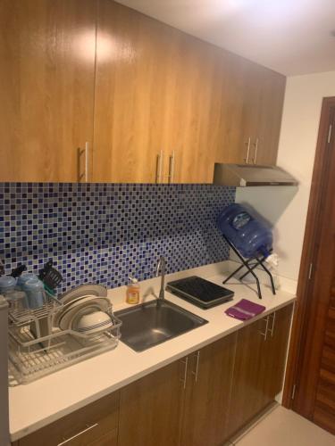 a kitchen with a sink and a counter top at Citadines II in Cebu City