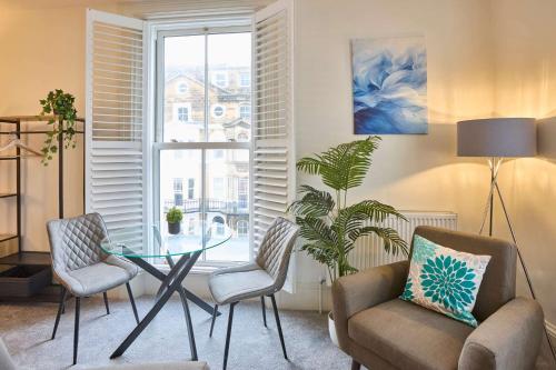 a living room with a glass table and chairs at Host & Stay - The Langley Hotel in Whitby