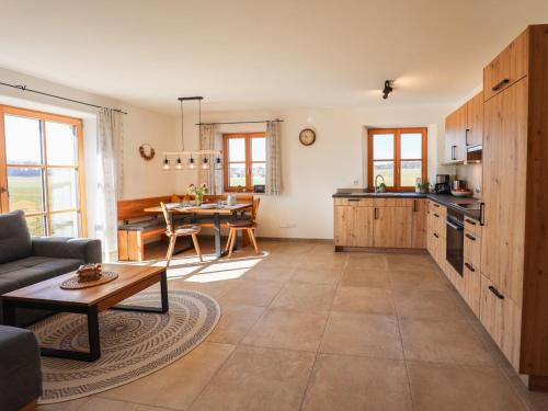 a living room with a table and a kitchen at Eberlhof in Schechen