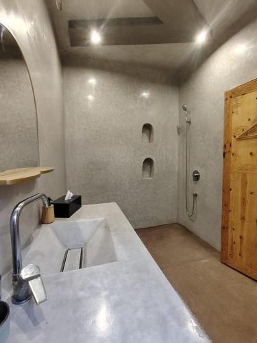 a bathroom with a sink and a shower at L'îlot in Sidi Ifni