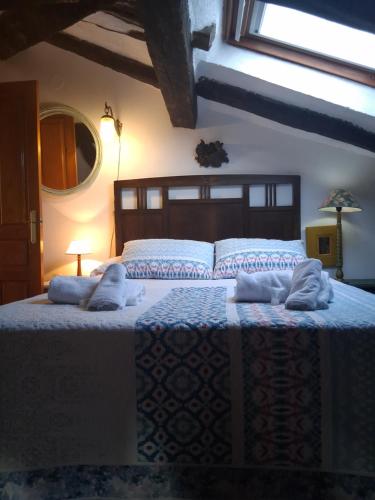 a bedroom with a bed with towels on it at R2R - Ático con encanto Colindres - C08B01 in Colindres