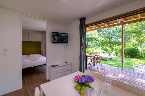 een kamer met een slaapkamer en een balkon met een tafel bij Camping Barco Reale in Lamporecchio