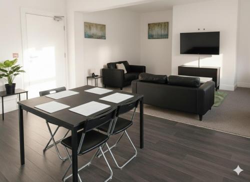 a living room with a table and a couch at Esk View House,Carlisle in Carlisle