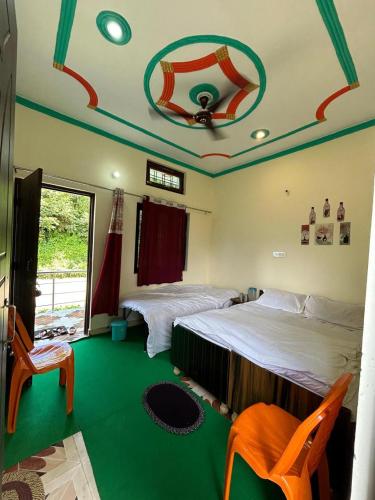a bedroom with two beds and a green floor at Shree Kedar dham Guest House in Gupta Kāshi