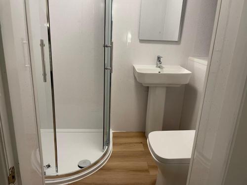 a bathroom with a shower and a toilet and a sink at The Guest Room in Aldridge